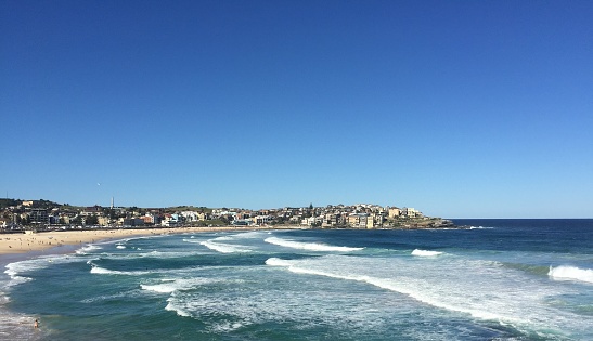 Bondi Beach with waves, blue water and sky in Sydney, Australia