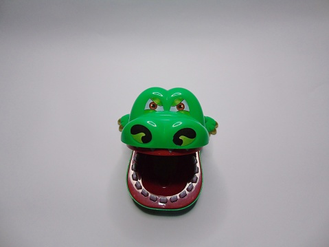 A photo of a toy crocodile on a white background