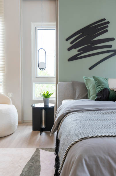 istock Modern bedroom interior with green wall and wall art. 1474342512