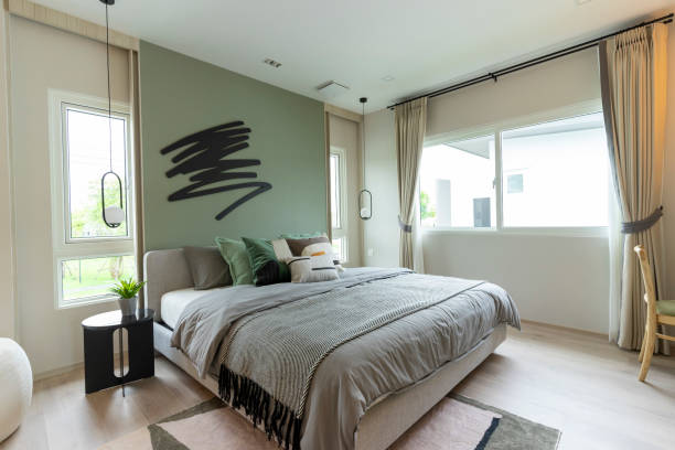 Modern bedroom interior with green wall and wall art.
