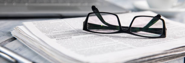 istock glasses on newspaper 1474343107