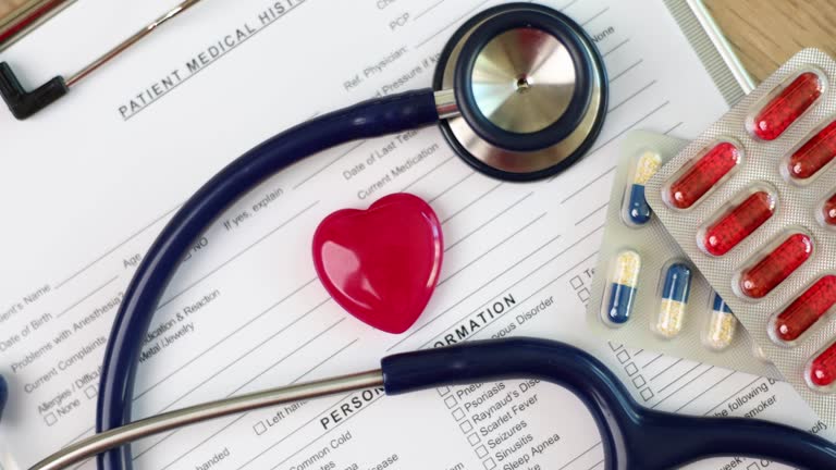 Patient history form with red heart, stethoscope and pills