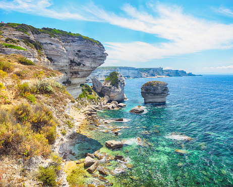 Cliffs above the Mediterranean sea near old town Bonifacio, Corsica, France. Composite photo