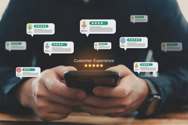istock Customer review good rating concept, hand pressing smartphone and five star icon on visual screen for positive customer feedback. 1474346752