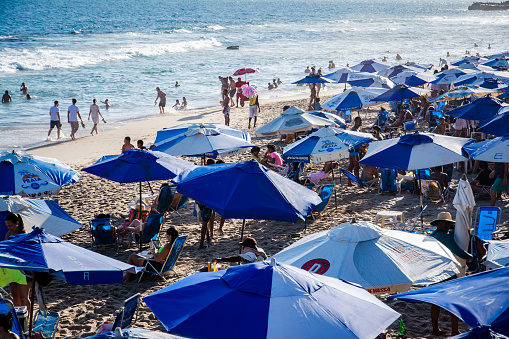 Salvador, Bahia, Brazil - October 22, 2022: Praia do Farol da Barra crowded with tourists bathing and relaxing on a hot day. Salvador, Bahia.