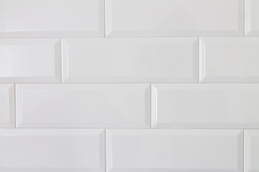 Background of white ceramic brick tile wall, close-up