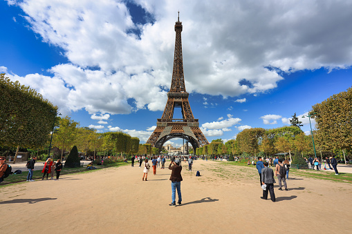 Paris, France - September 17, 2022: People on the walk at Park Champ de Mars by the Eiffel Tower in Paris. France