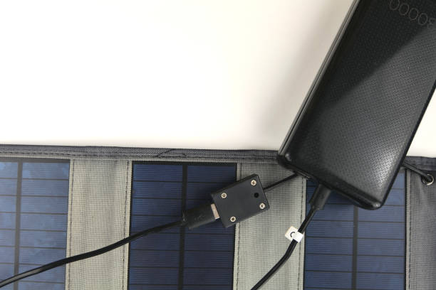 istock A big black power bank is being charged from a portable solar panel on a white background 1474351322