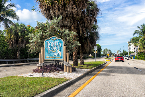 Bonita Springs, USA - November 2, 2021: Pov car driving on Bonita Beach Road Florida state road 865 to Bonita Beach with welcome sign in Lee county