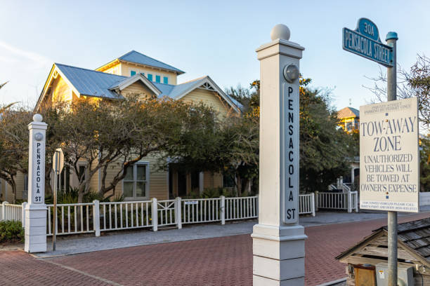 Modern buildings in new urbanism architecture by beach at Seaside, Florida in winter sunset with parking sign and Pensacola street Seaside, USA - January 14, 2021: Modern buildings in new urbanism architecture by beach at Seaside, Florida in winter sunset with parking sign and Pensacola street new urbanism stock pictures, royalty-free photos & images