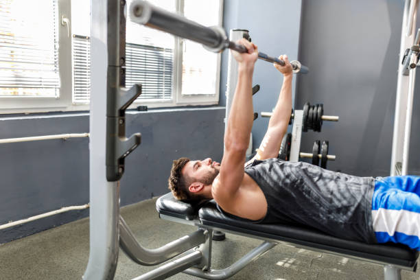 istock Young handsome man is doing exercises in a gym. 1474353161