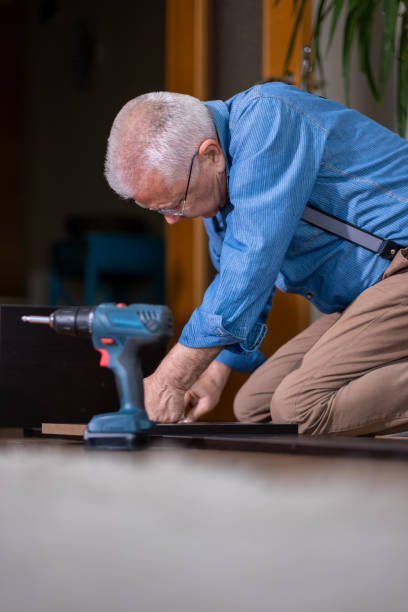 istock senior man carpenter doing home repairs 1474353178