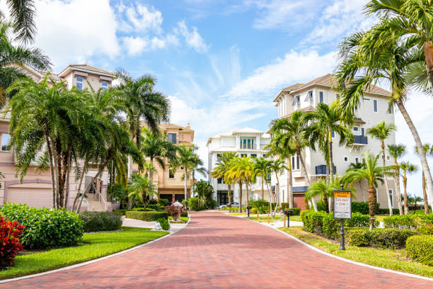 Barefoot beach boulevard road residential community in Florida with luxury houses real estate property homes in tropical climate stock photo