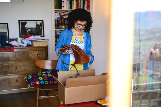istock multiracial female unpacking parcel cardboard box with online purchase. 1474355554