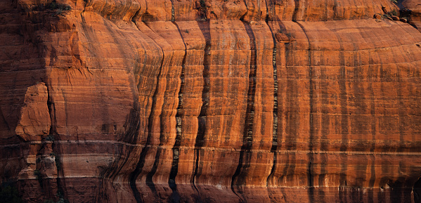Closeup view of a sandstone rock face in Sedona, Arizona.