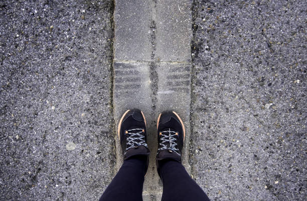 istock Woman's feet on the asphalt 1474358820