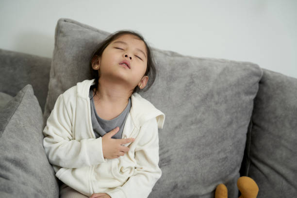Unwell Children touching on her chest pain from Asthma Unwell Asian Children touching on her chest pain from Asthma unhealthy asian kid stock pictures, royalty-free photos & images