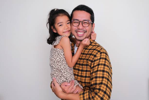 A father carry and hugging his daughter with happy expression A father carry and hugging his daughter with happy expression keluarga stock pictures, royalty-free photos & images