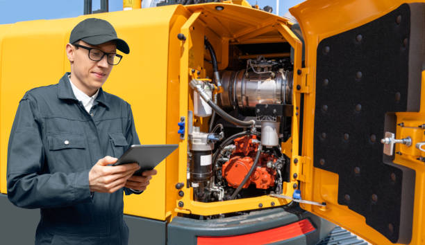 istock Serviceman on the background of construction machine 1474361506
