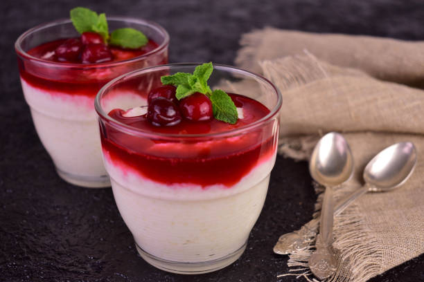 istock Delicate rice pudding with sweet and sour cherry jam on a black background. 1474361842
