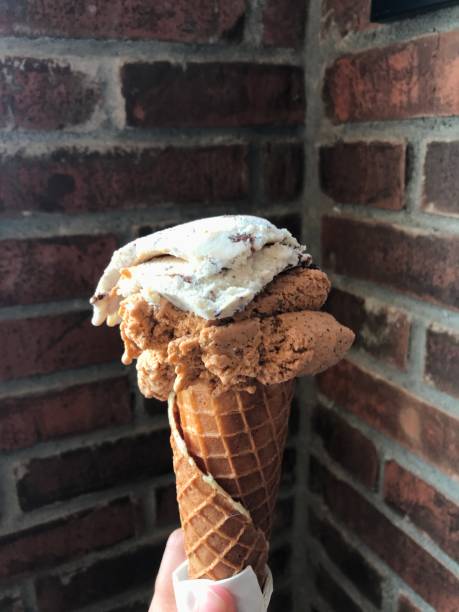 istock Gelato ice cream cone on a brick background. 1474364308