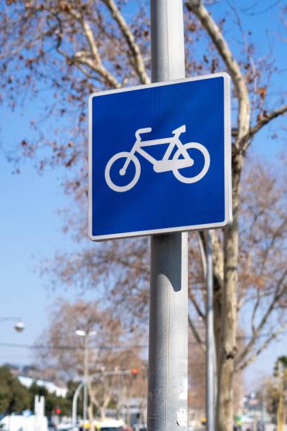 istock Traffic sign for a cycle lane surrounded by leafy plants on a sunny day. 1474364401