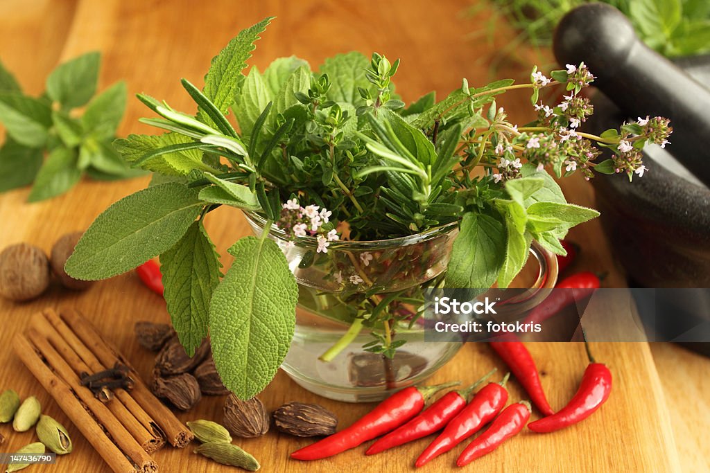 Herbs and spices Spices and bunch of fresh aromatic herbs in glass. Allspice Stock Photo