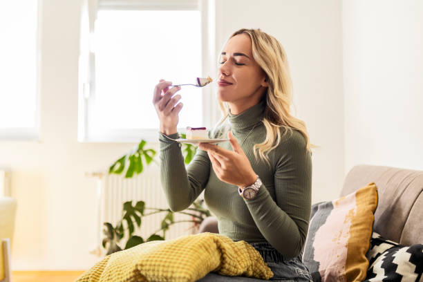 istock Woman holding in hands cup eating cake 1474369417