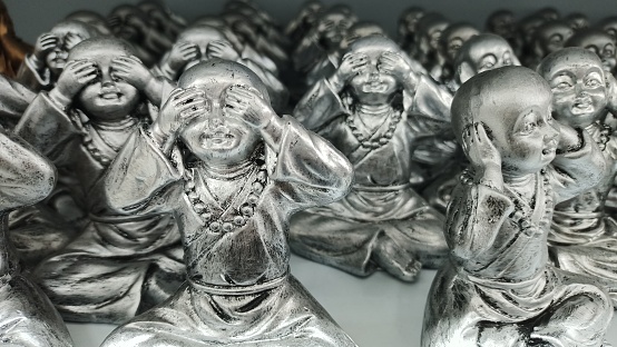 Metal statues of a boy who pretends not to hear, see and speak. High quality photo