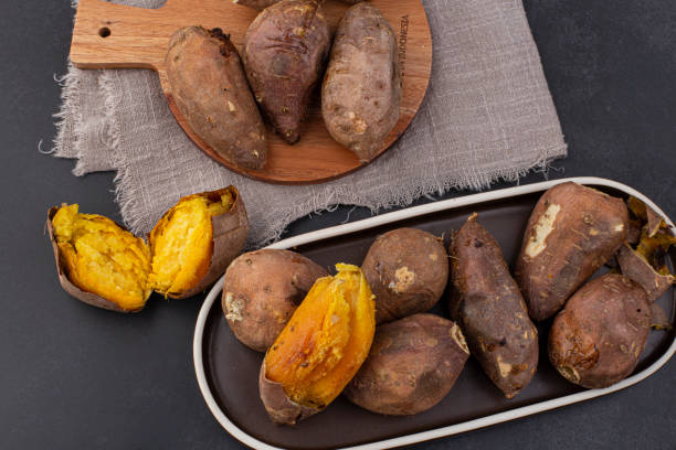 istock roasted sweet potatoes on a black background 1474370882