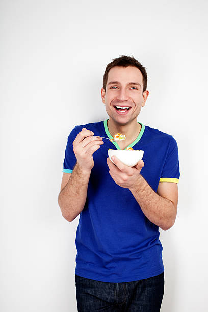 istock Young smiling man eating musli 147437195