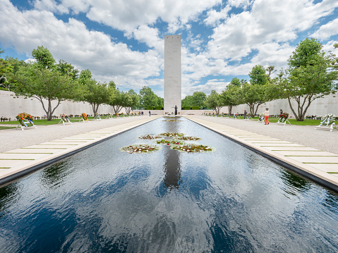 Twinsburg, OH, USA - July 4, 2015: A fallen soldier tribute stands before panels of a replica Vietnam Memorial Wall, on tour with the Cost of Freedom tribute, a traveling veterans-based exhibit