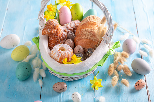 Traditional Easter basket as Traditions on Holy Sunday in Easter. Cake, catkins and Easter eggs for Easter.