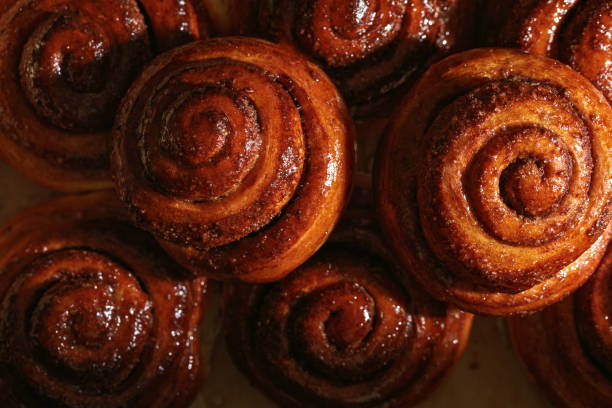 istock Freshly baked homemade Cinnamon rolls or Cinnamon buns on baking paper 1474376535