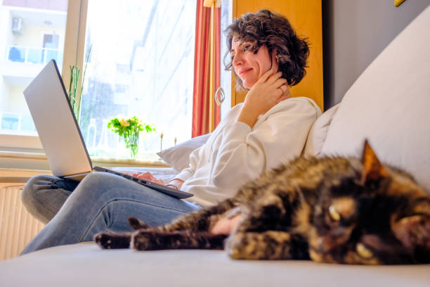 istock Sleeping cat and smiling woman, low angle view 1474377036