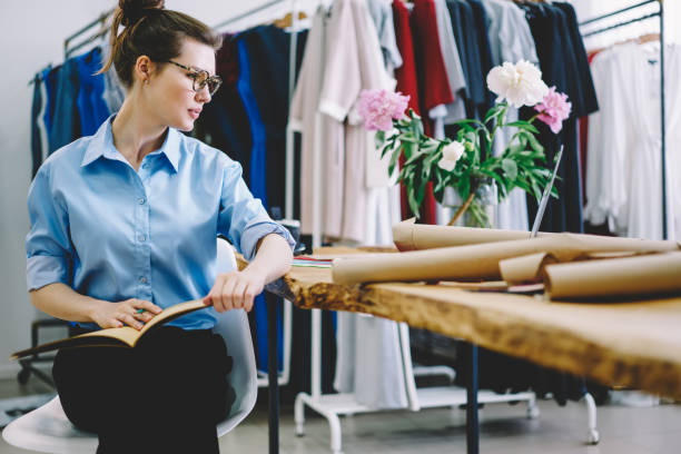 istock Serious lady drawing sketches in dress workshop 1474377715