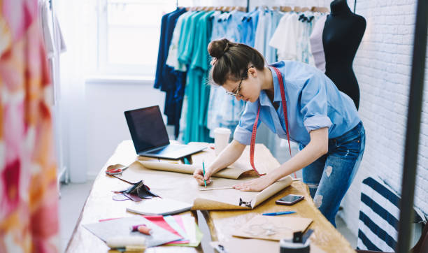 istock Concentrated female designer drawing on paper in studio 1474377760