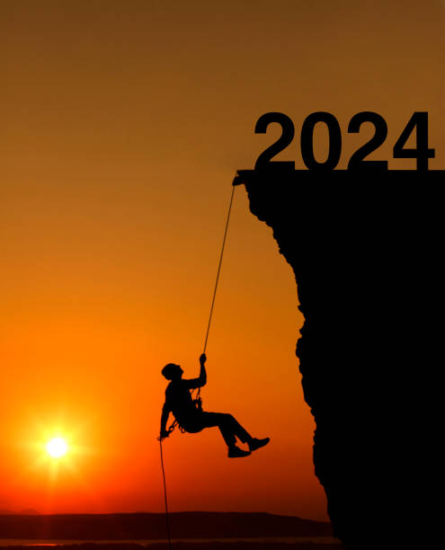 Man rock climbing to 2024