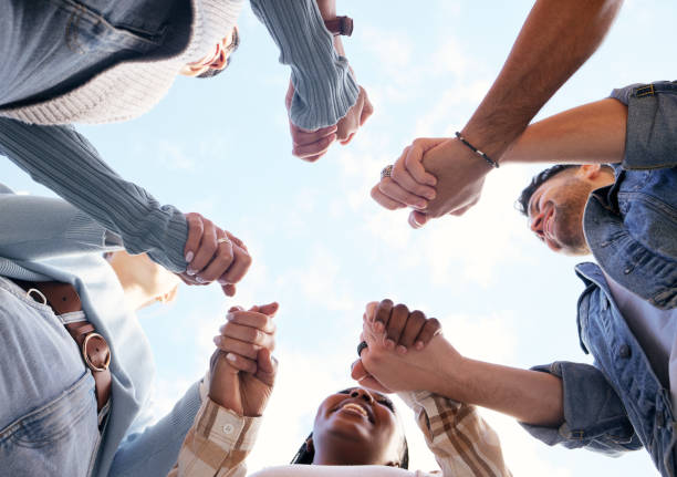 istock Support, teamwork or students holding hands with goals, educational community or hope for future success. University, team building or happy friends in partnership or college with a mission or vision 1474378387