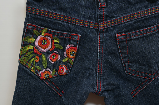 Embroidered flowers on jeans pocket