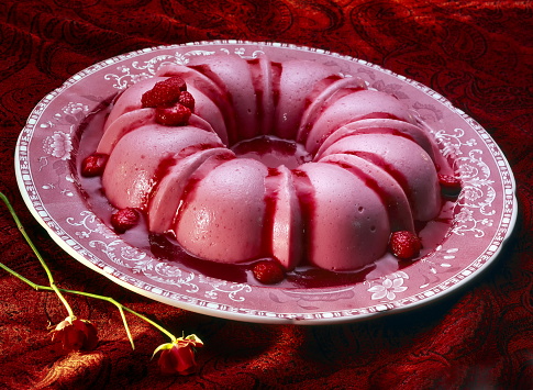 strawberry pudding with strawberry sauce on plate
