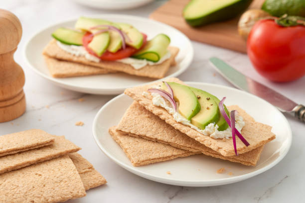 istock Plates with crispbread with different toppings. Low angle view. Studio shot. 1474381468