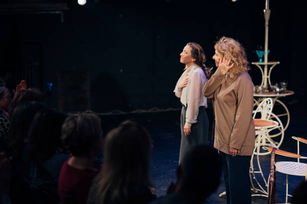 istock Two professional actresses bow to the audience after the performance 1474383120