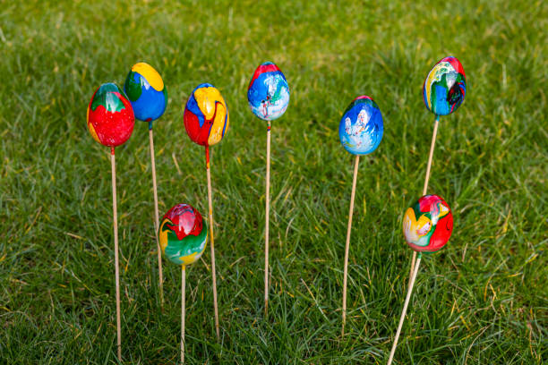 istock Close up of colored Easter eggs isolated against green grass outside 1474386246