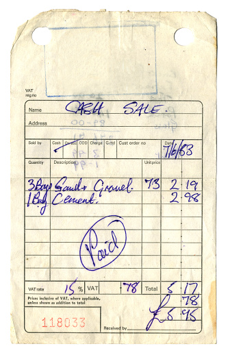 A grubby, stained and torn receipt for sand, gravel and cement issued in 1983. The total cost was £5.95, including VAT. (All identifying details have been removed.)