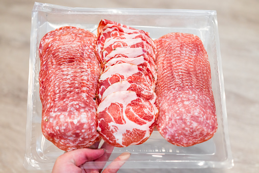 Salami slices with uncured sopressata, coppa and genoa salami with no nitrites on plastic tray with red meat pork