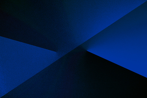 Dark blue abstract modern background for design. Geometric shape. Triangles, diagonal lines. Gradient.