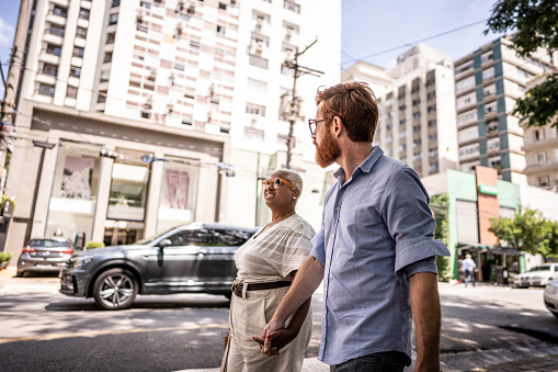 Mature couple walking while talk in the city