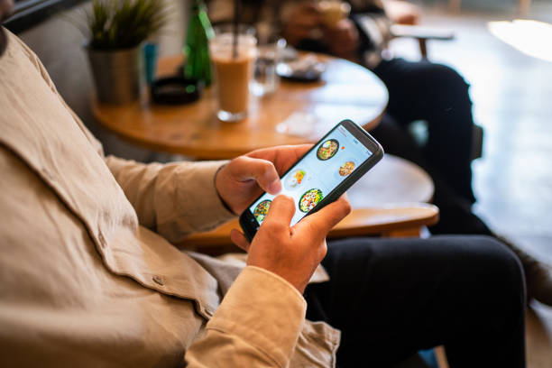 istock Young man shopping online at cafe 1474396293