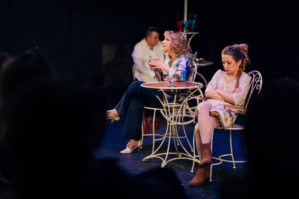 istock Two actresses perform in front of the audience. The actor sits behind them 1474396498